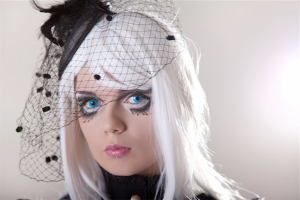 Halloween injuries: headshot of girl in costume with platinum hair and bright blue eyes wearing bird's nest veil