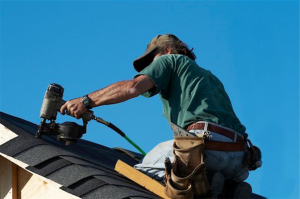 Photo of worker repairing a roof