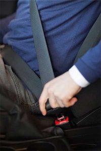 Photo of man fastening seat belt over his lap