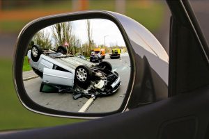 View of motor vehicle accident through car's sideview mirror.
